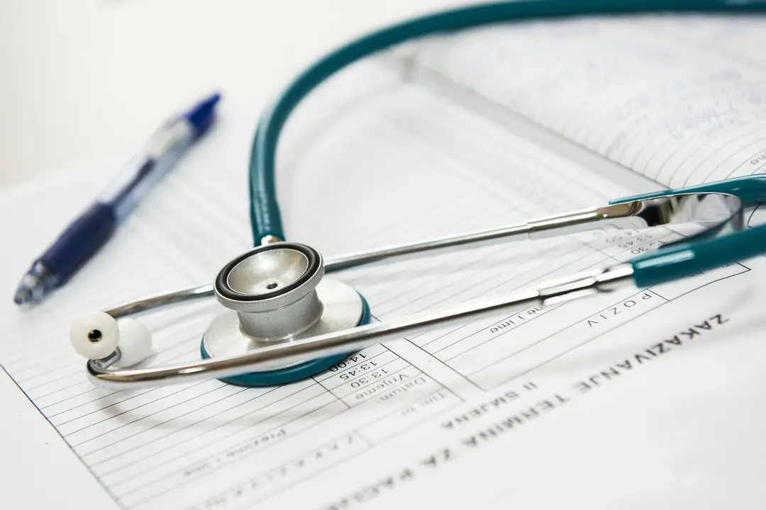 A medical stethoscope on top of a paper document