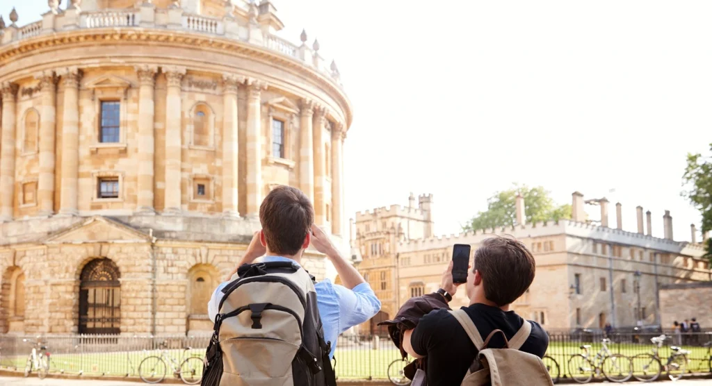 Students taking photos of the Radcliffe Camera in Oxford, UK
