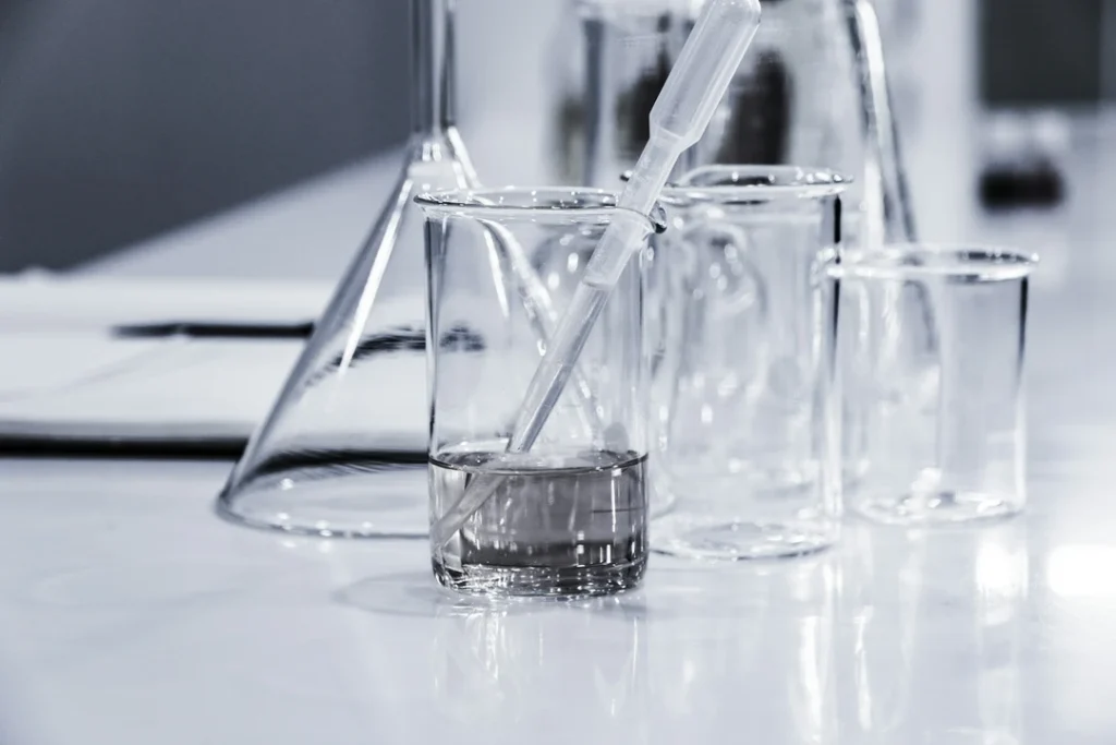 Clear beakers and equipment on a lab table
